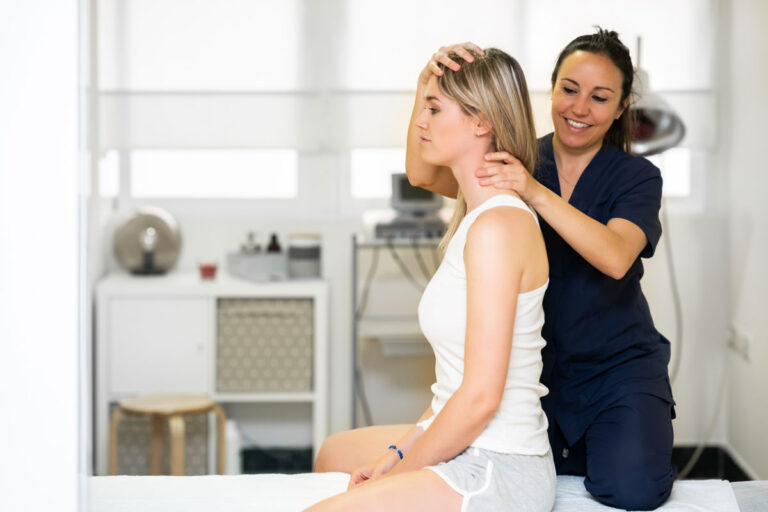 Physiotherapist performing a neck mobility assessment on a seated female patient in a bright, modern clinic setting.